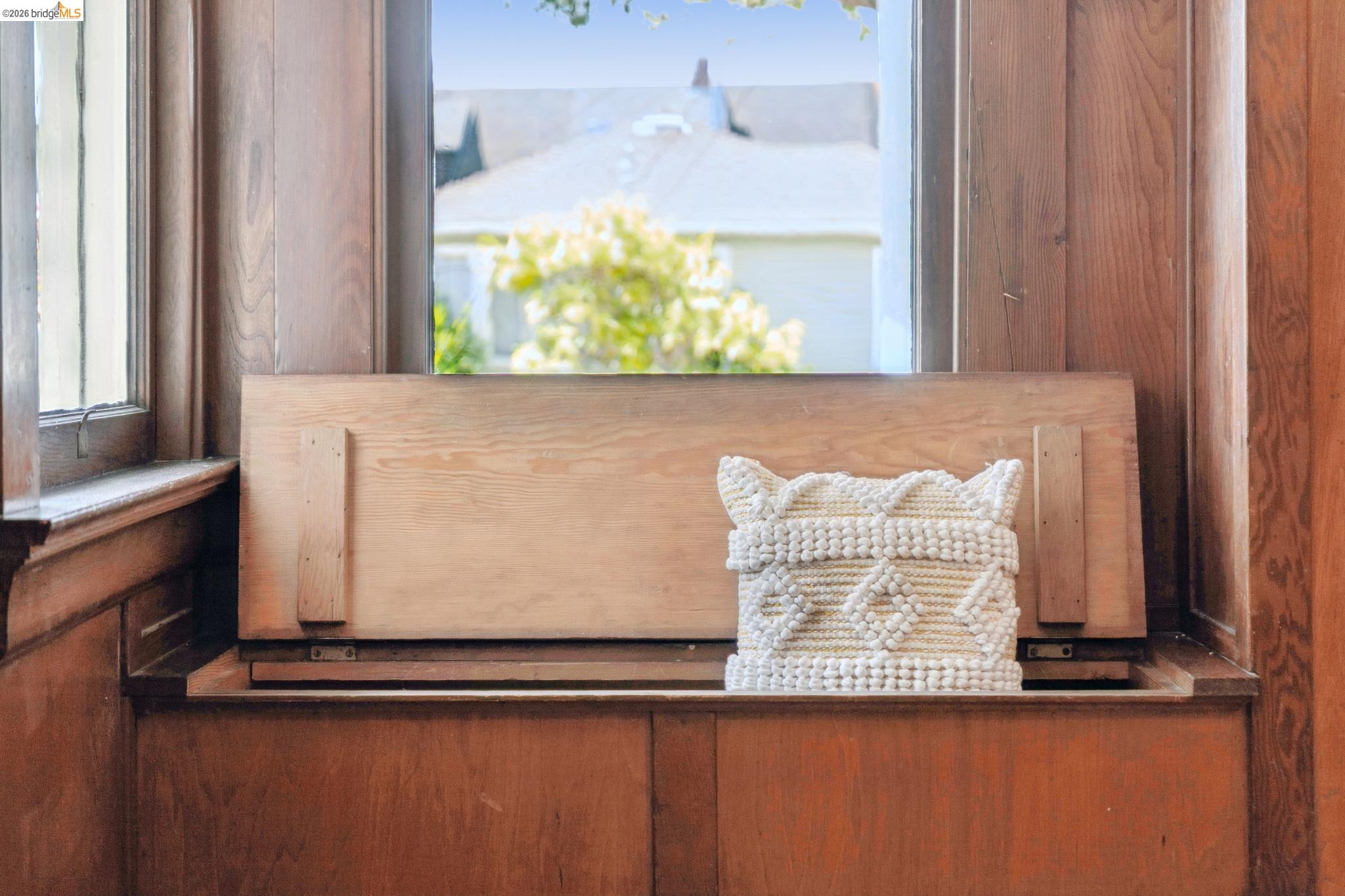 1701 Derby Street Berkeley, CA 94703 - Photo 18 of 39 Built-in window seating crafted from wood paneling, featuring a hinged storage compartment and a wood-framed window