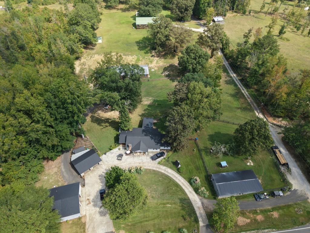 an aerial view of residential houses with outdoor space and trees