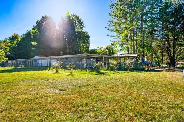 a view of a swimming pool with an outdoor seating and a yard