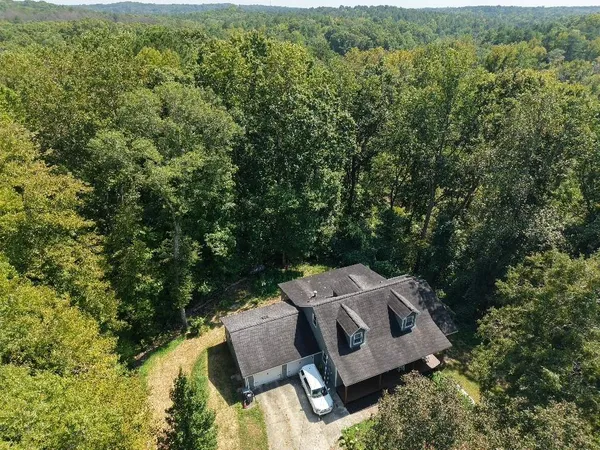 an aerial view of a house with yard and outdoor seating