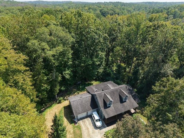 an aerial view of a house with yard and outdoor seating