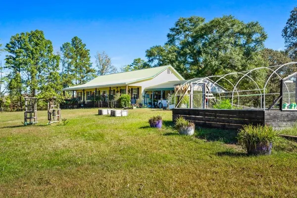 a view of swimming pool with outdoor seating and garden