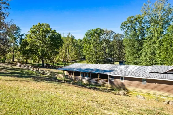 a view of a house with a yard and swimming pool