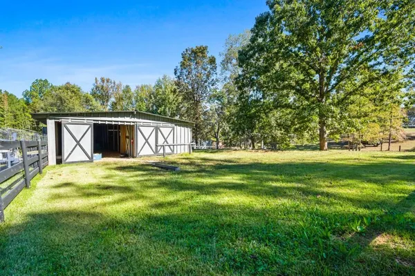 a front view of a house with a yard table and chairs