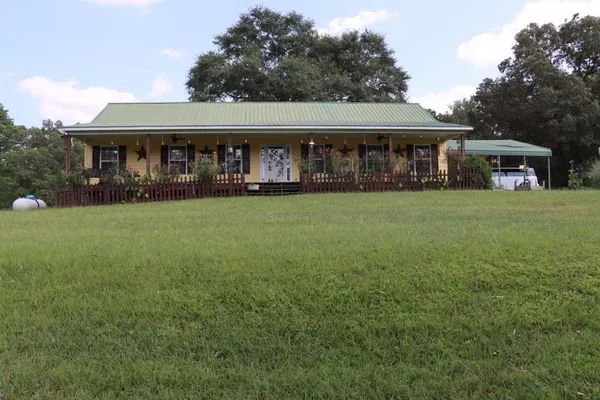 a front view of house with yard outdoor seating and green space