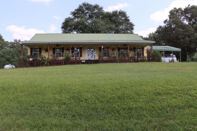a front view of house with yard outdoor seating and green space