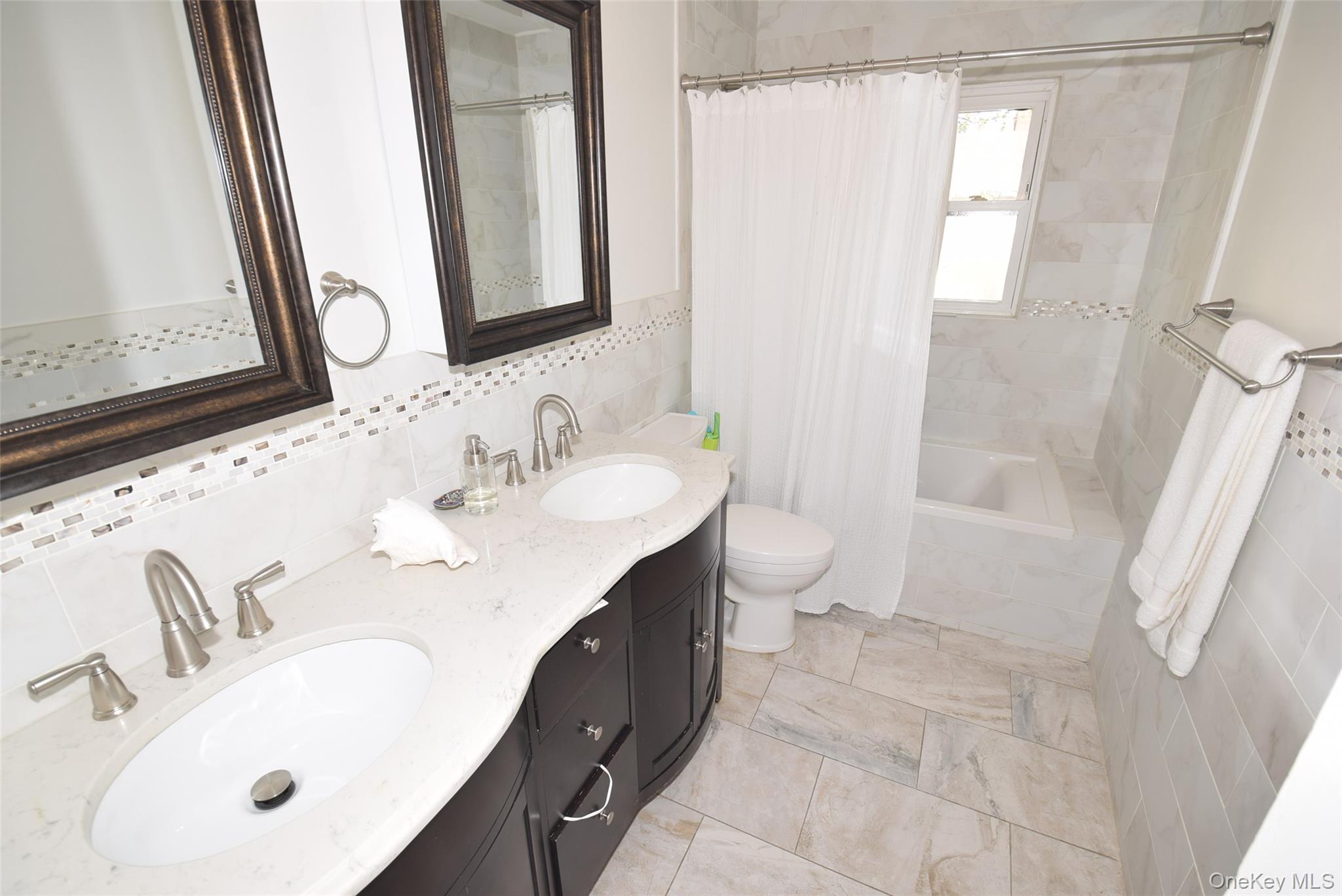 105-48 65th Road Queens, NY 11375 - Photo 13 of 17 a bathroom with a sink and a mirror