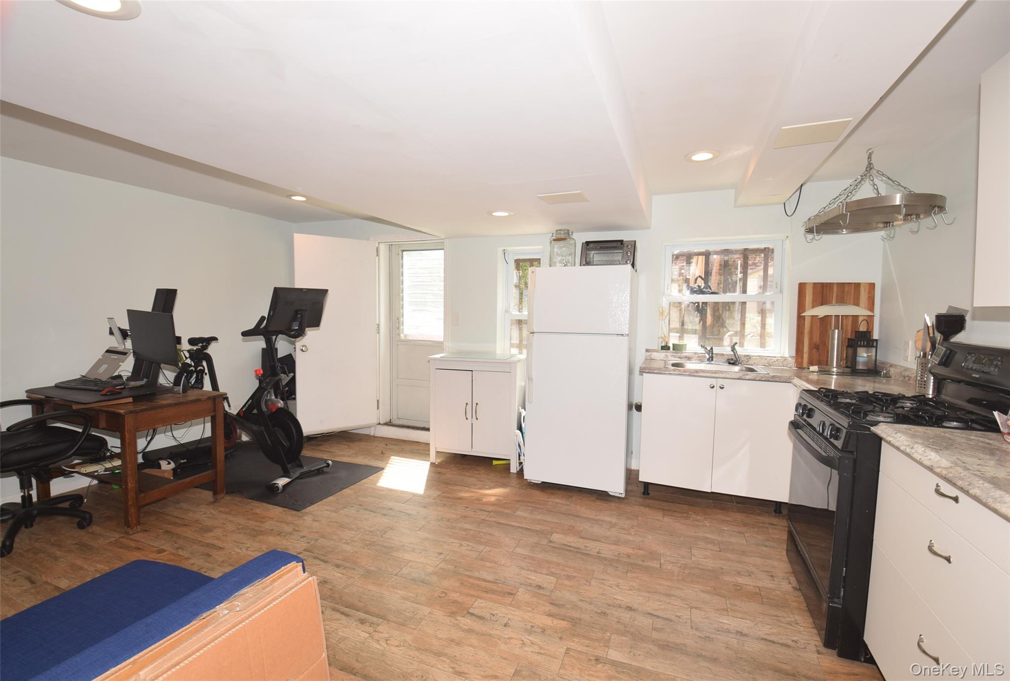 105-48 65th Road Queens, NY 11375 - Photo 14 of 17 a view of a kitchen with refrigerator and workspace