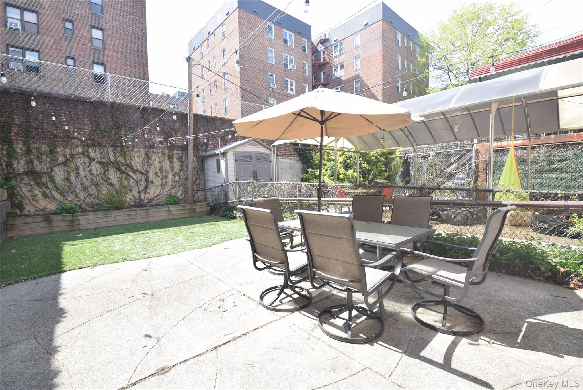 105-48 65th Road Queens, NY 11375 - Photo 17 of 17 a view of backyard with outdoor seating and plants