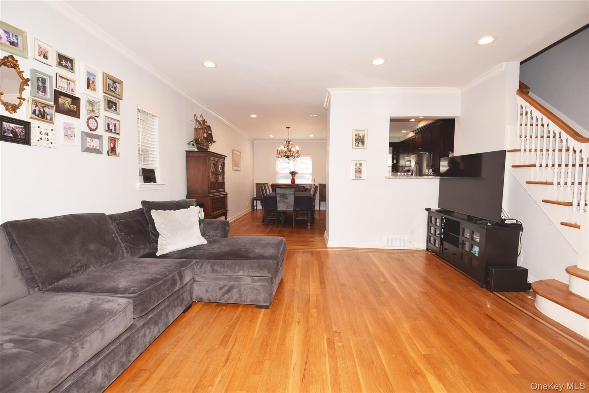 105-48 65th Road Queens, NY 11375 - Photo 3 of 17 a living room with furniture and a flat screen tv