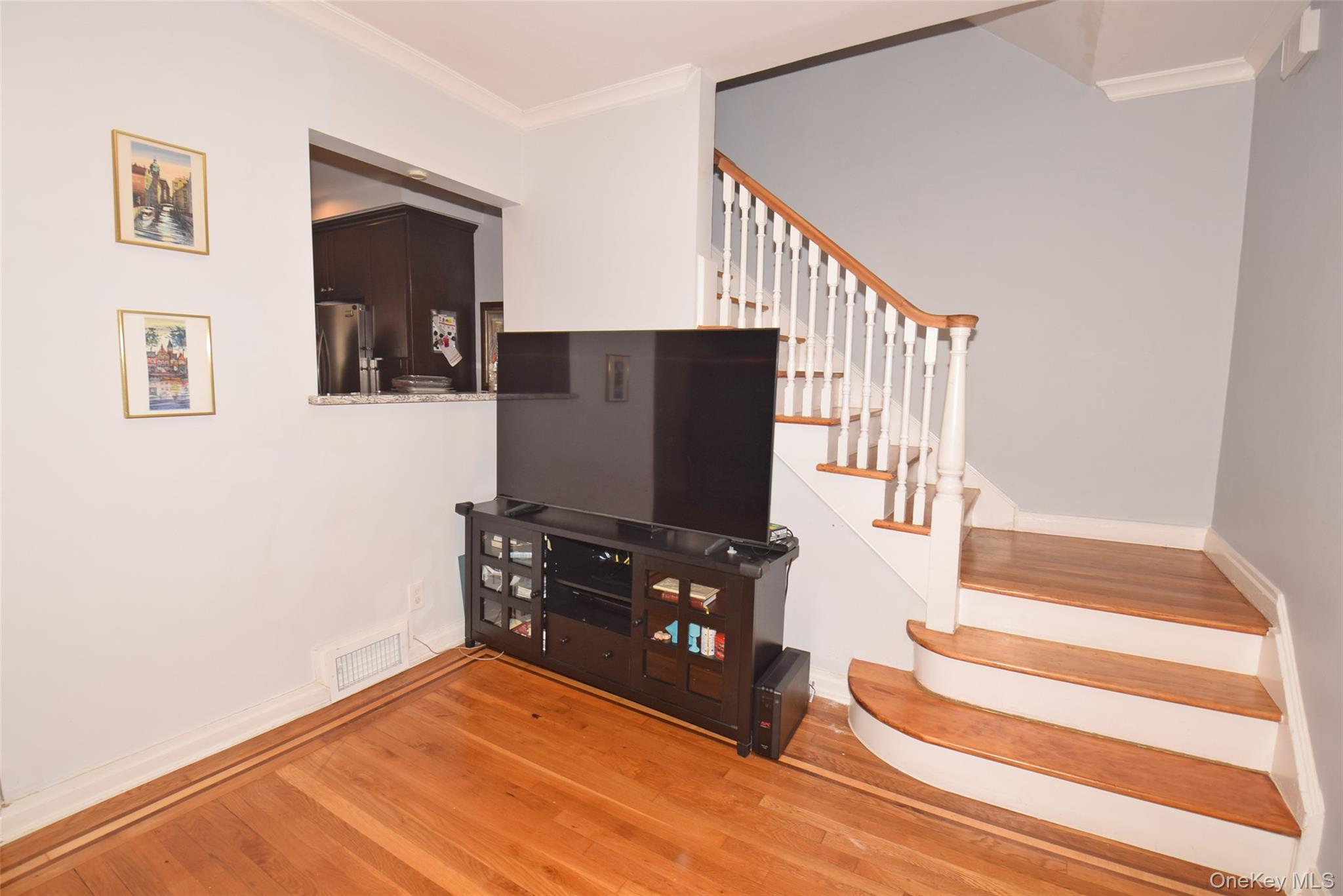 105-48 65th Road Queens, NY 11375 - Photo 4 of 17 a living room with wooden floor and furniture