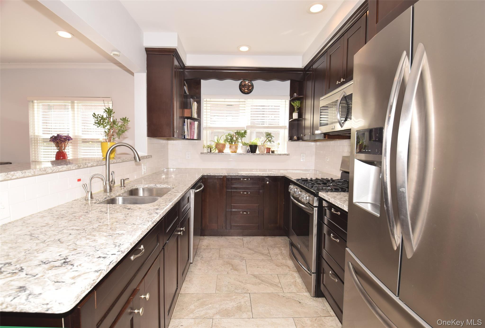 105-48 65th Road Queens, NY 11375 - Photo 8 of 17 a large kitchen with granite countertop a sink stove and refrigerator