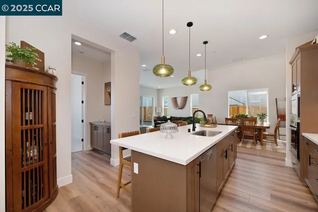 a kitchen with a sink a counter top space and stainless steel appliances