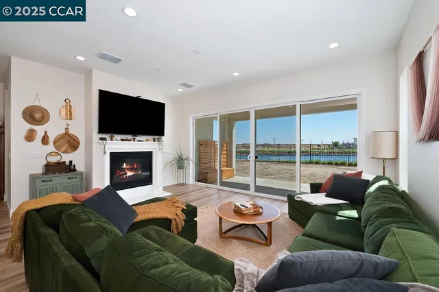 a living room with furniture a flat screen tv and a fireplace