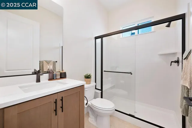 a bathroom with a sink mirror toilet and shower
