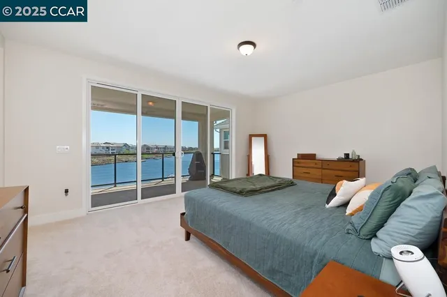 a bedroom with furniture and a large window