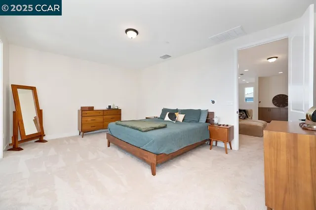 a living room with furniture a flat screen tv and a table