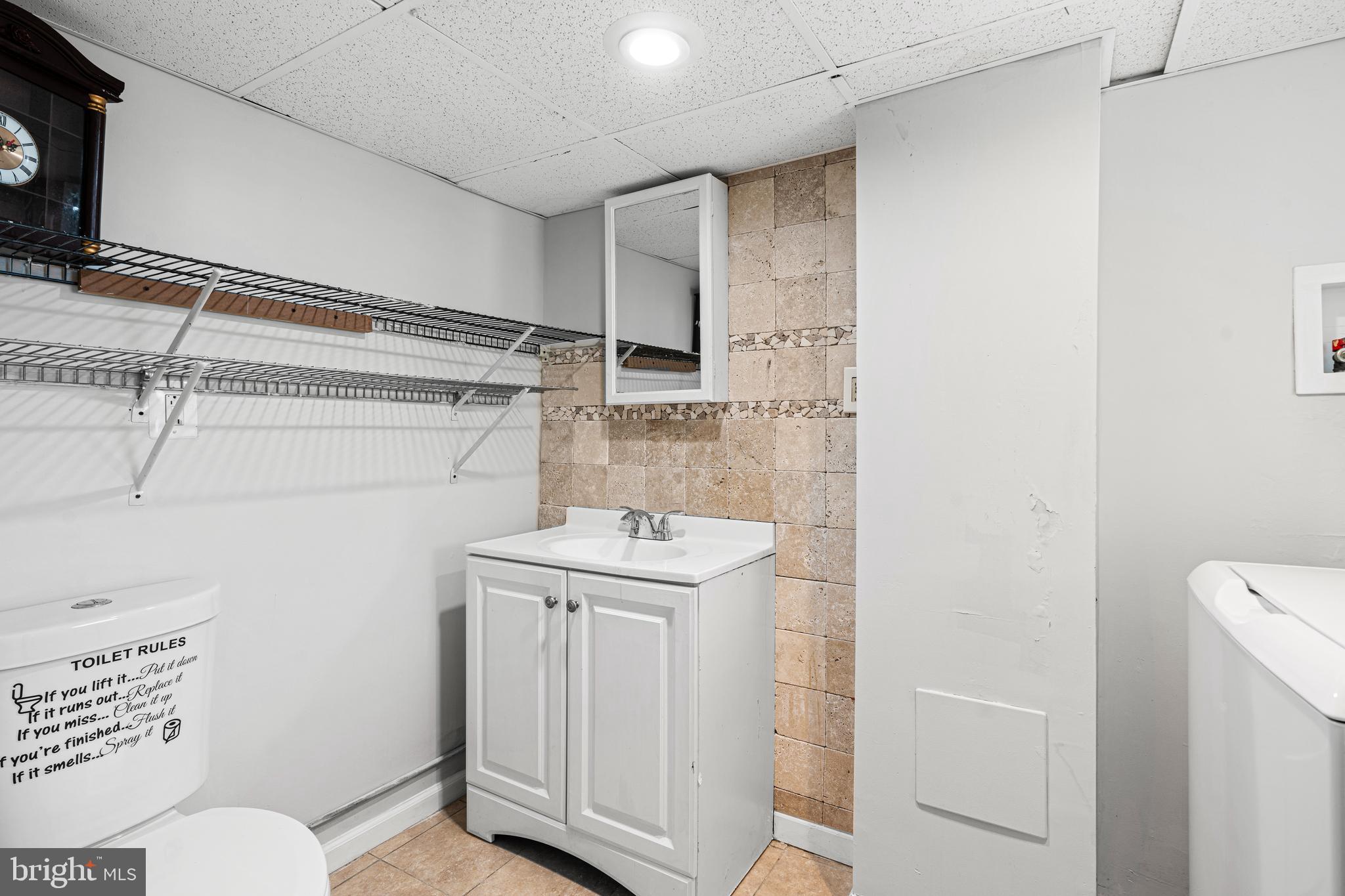 1344 Sunset Street Marcus Hook, PA 19061 - Photo 19 of 22 a bathroom with a sink a toilet and vanity