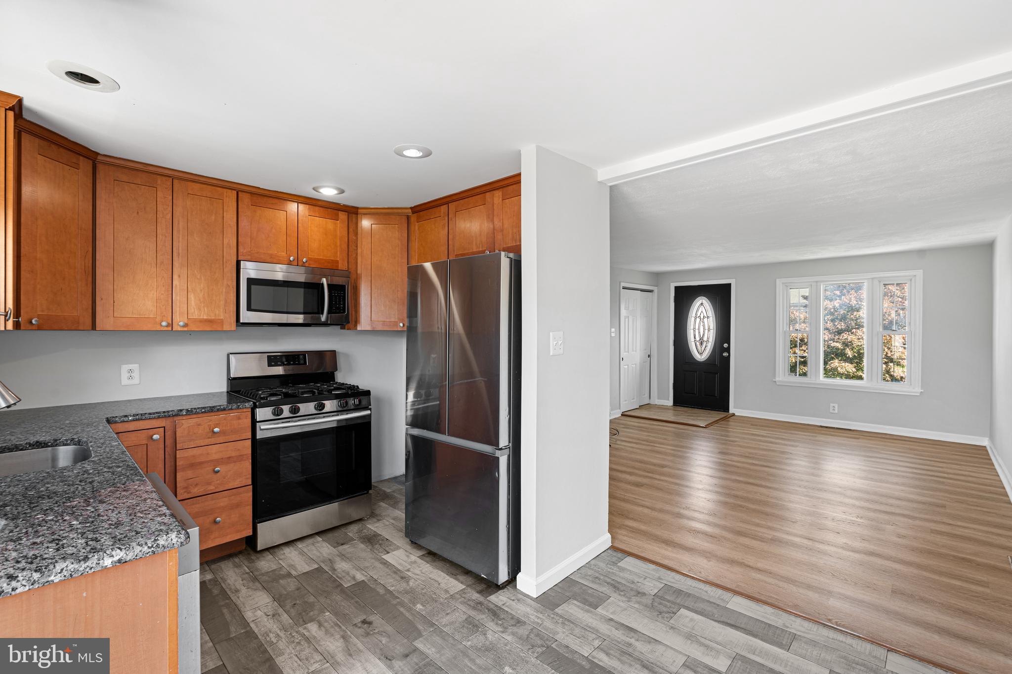 1344 Sunset Street Marcus Hook, PA 19061 - Photo 6 of 22 a kitchen with granite countertop a refrigerator stove and oven