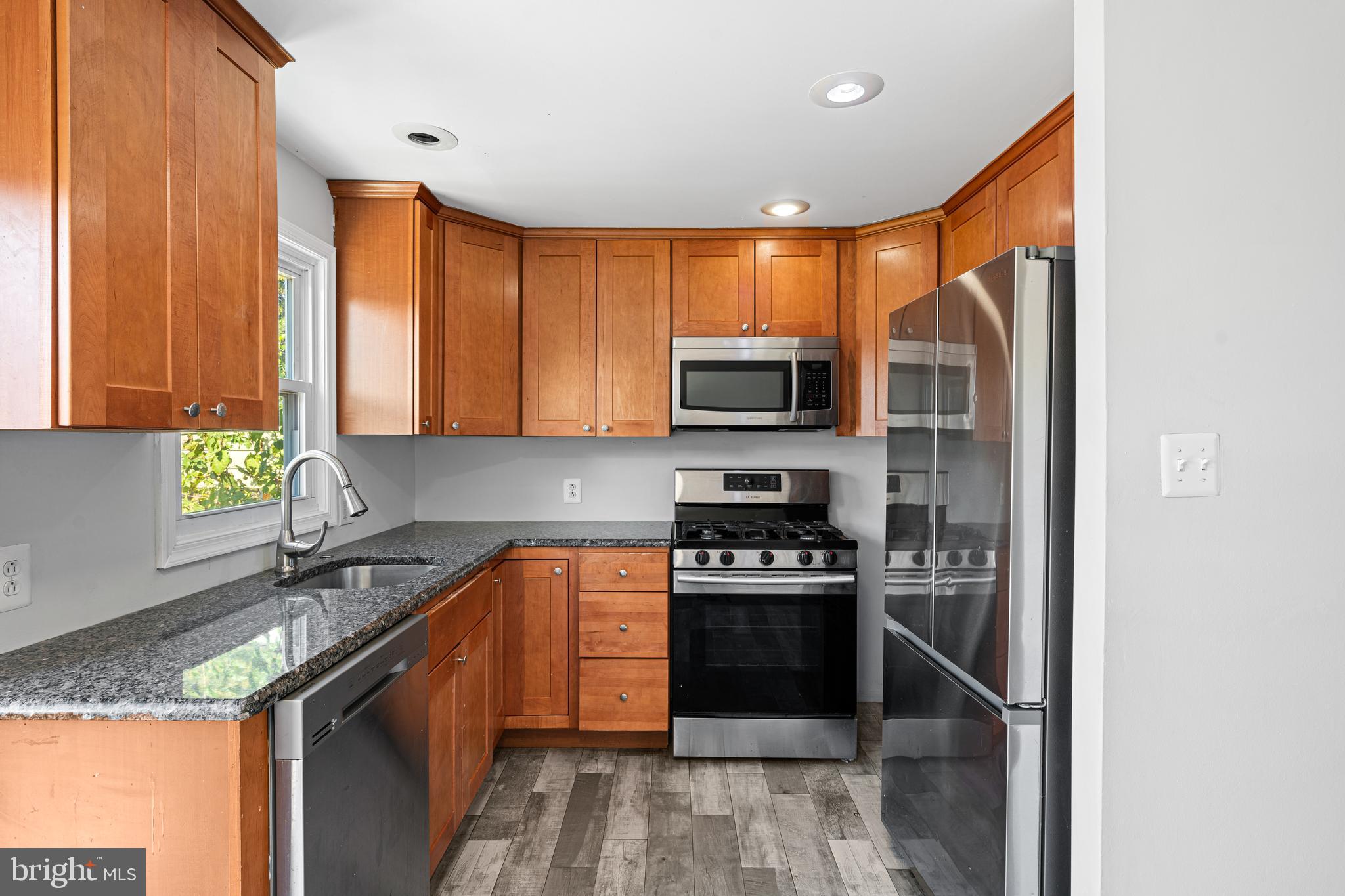 1344 Sunset Street Marcus Hook, PA 19061 - Photo 7 of 22 a kitchen with stainless steel appliances granite countertop a stove a sink and a microwave