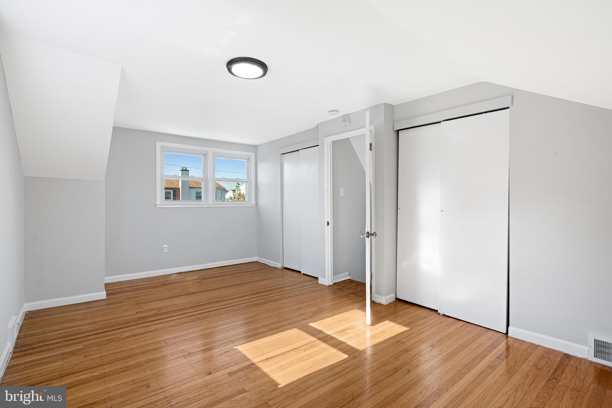 1344 Sunset Street Marcus Hook, PA 19061 - Photo 9 of 22 a view of an empty room with wooden floor and a window