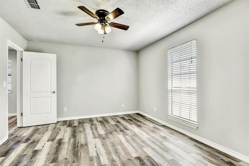 925 Farmington Road Howe, TX 75459 - Photo 7 of 14 a view of empty room with wooden floor and fan