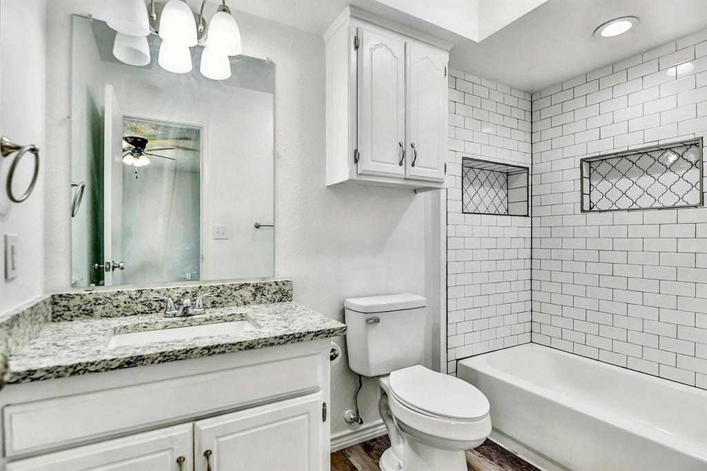 925 Farmington Road Howe, TX 75459 - Photo 9 of 14 a bathroom with a granite countertop toilet sink and mirror