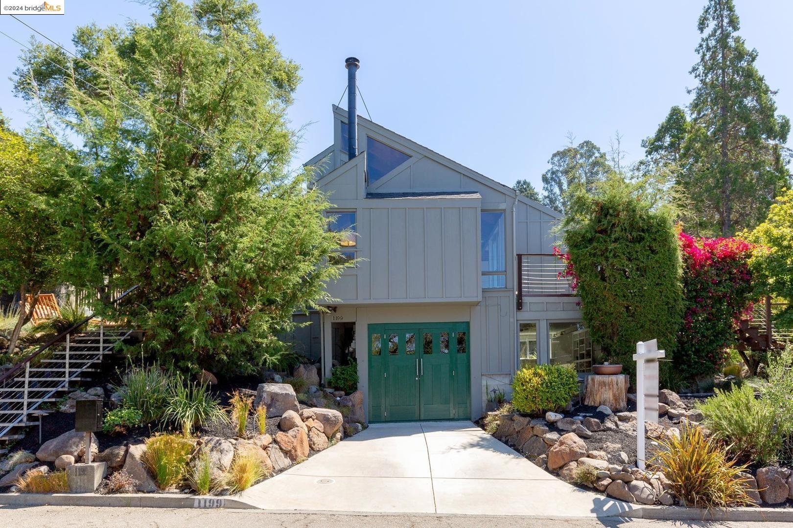 a front view of house with yard outdoor seating and green space