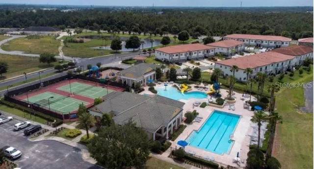 an aerial view of a house a yard and outdoor seating