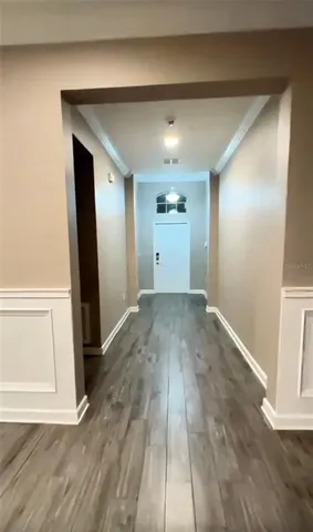 a view of empty room with wooden floor