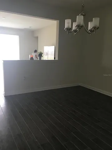 a view of a room with wooden floor and cabinet
