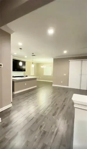 a view of a kitchen and an empty room