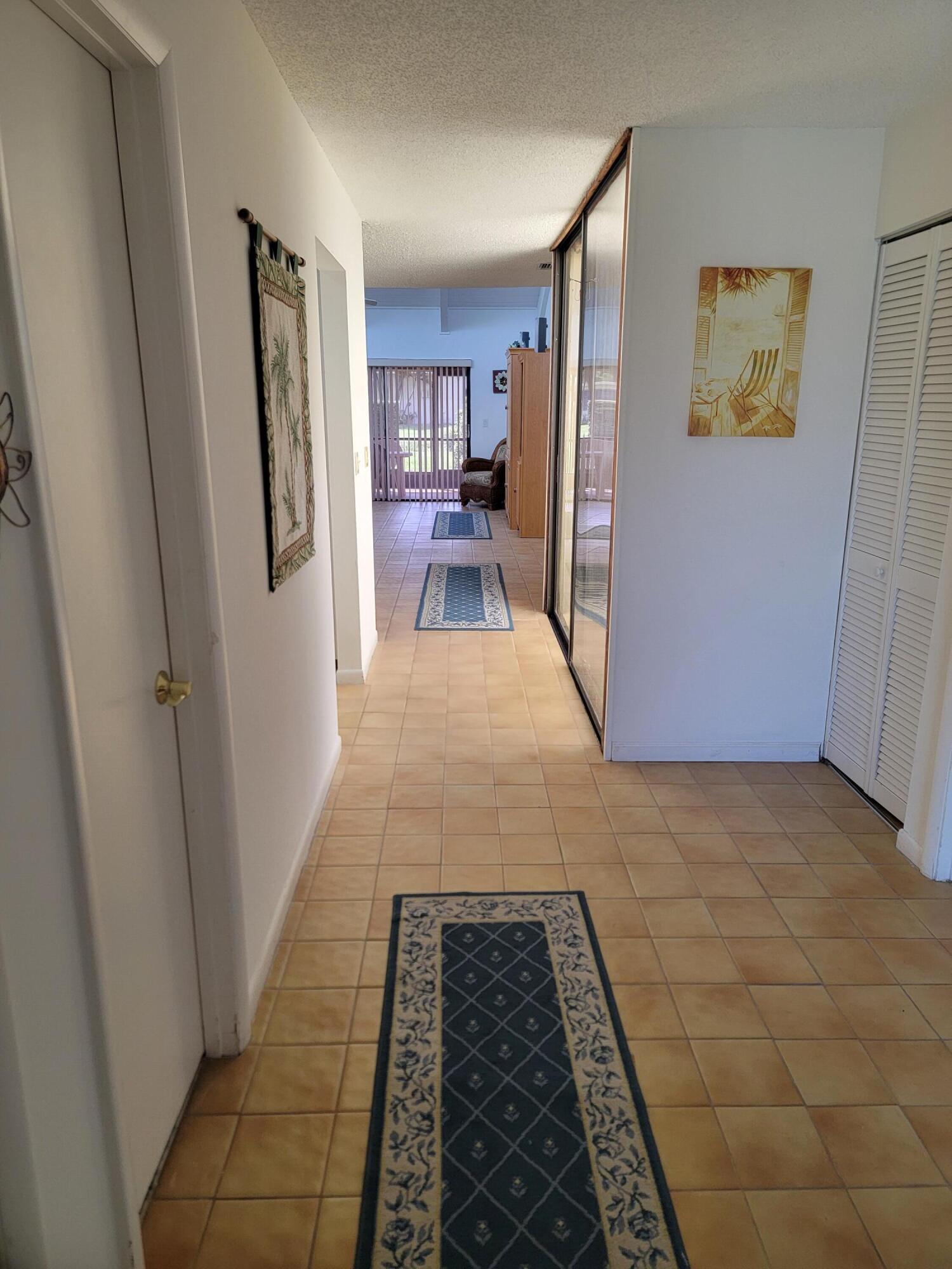 11115 Oakdale Road Boynton Beach, FL 33437 - Photo 17 of 30 a hallway view with wooden floor and living room