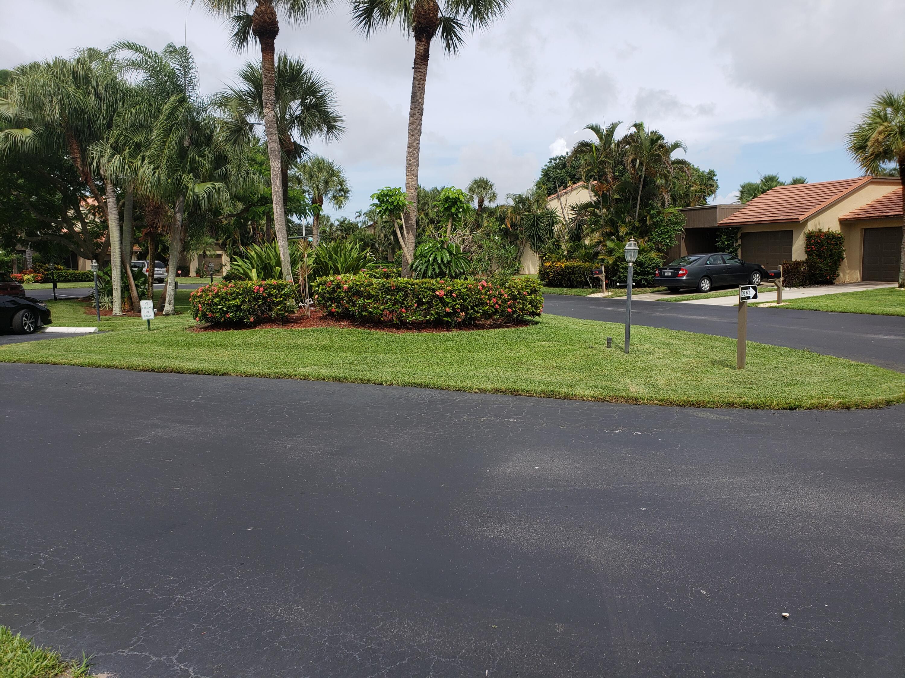 11115 Oakdale Road Boynton Beach, FL 33437 - Photo 3 of 30 a front view of a house with garden and trees