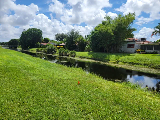 an aerial view of a house with a yard and lake view