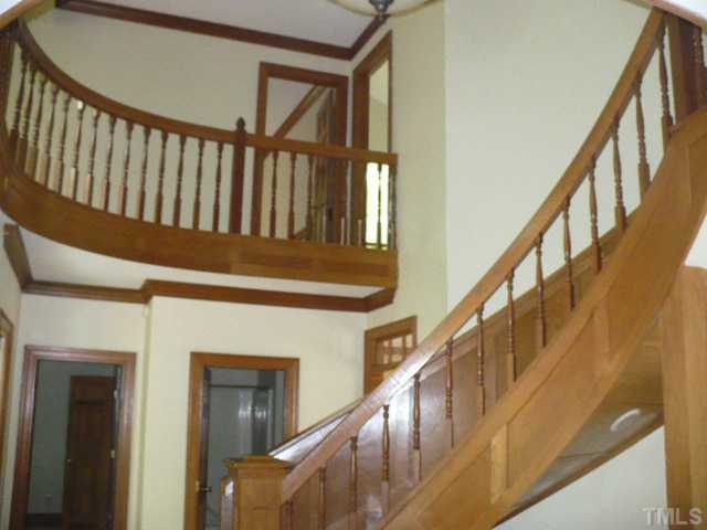228 Jansmith Lane Raleigh, NC 27615 - Photo 4 of 17 a view of staircase with railing and a window