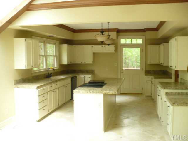 228 Jansmith Lane Raleigh, NC 27615 - Photo 5 of 17 a kitchen with a sink a stove and cabinets