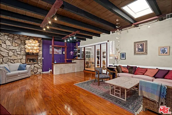 a living room with furniture a window and gym equipment