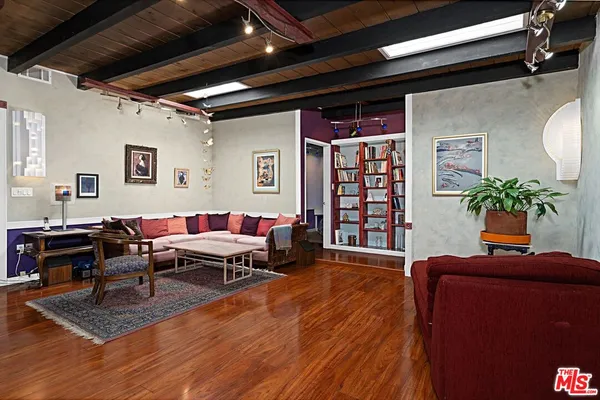 a view of a kitchen with furniture and wooden floor