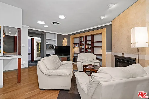 a very nice looking room with a large window and furniture