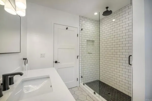 a bathroom with a shower and a sink