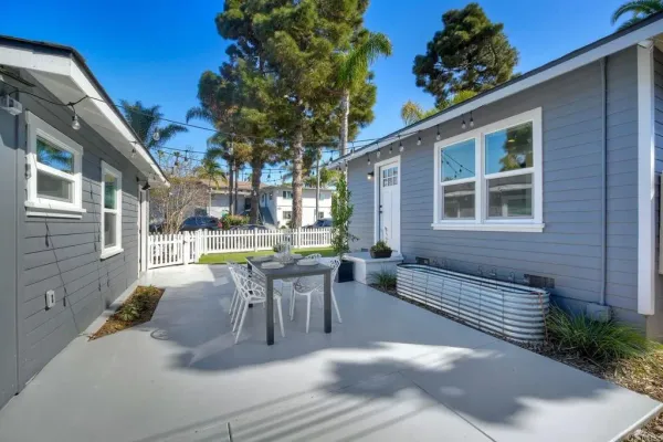 a view of a patio with table and chairs and potted plants