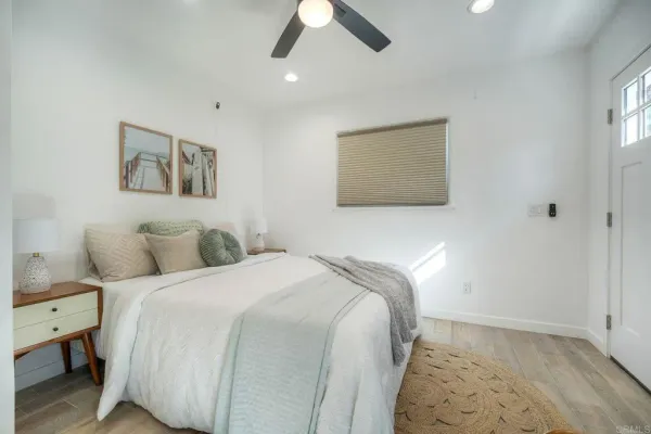 a bedroom with a bed and a painting on the wall