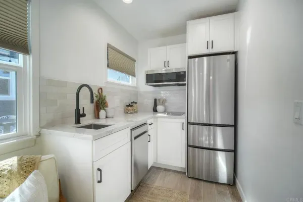 a kitchen with appliances a sink and cabinets