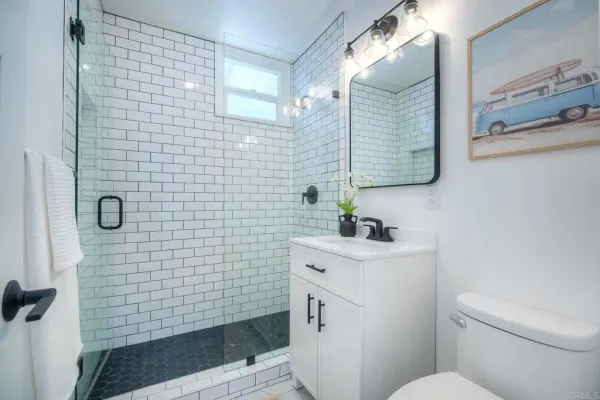 a bathroom with a sink toilet and shower