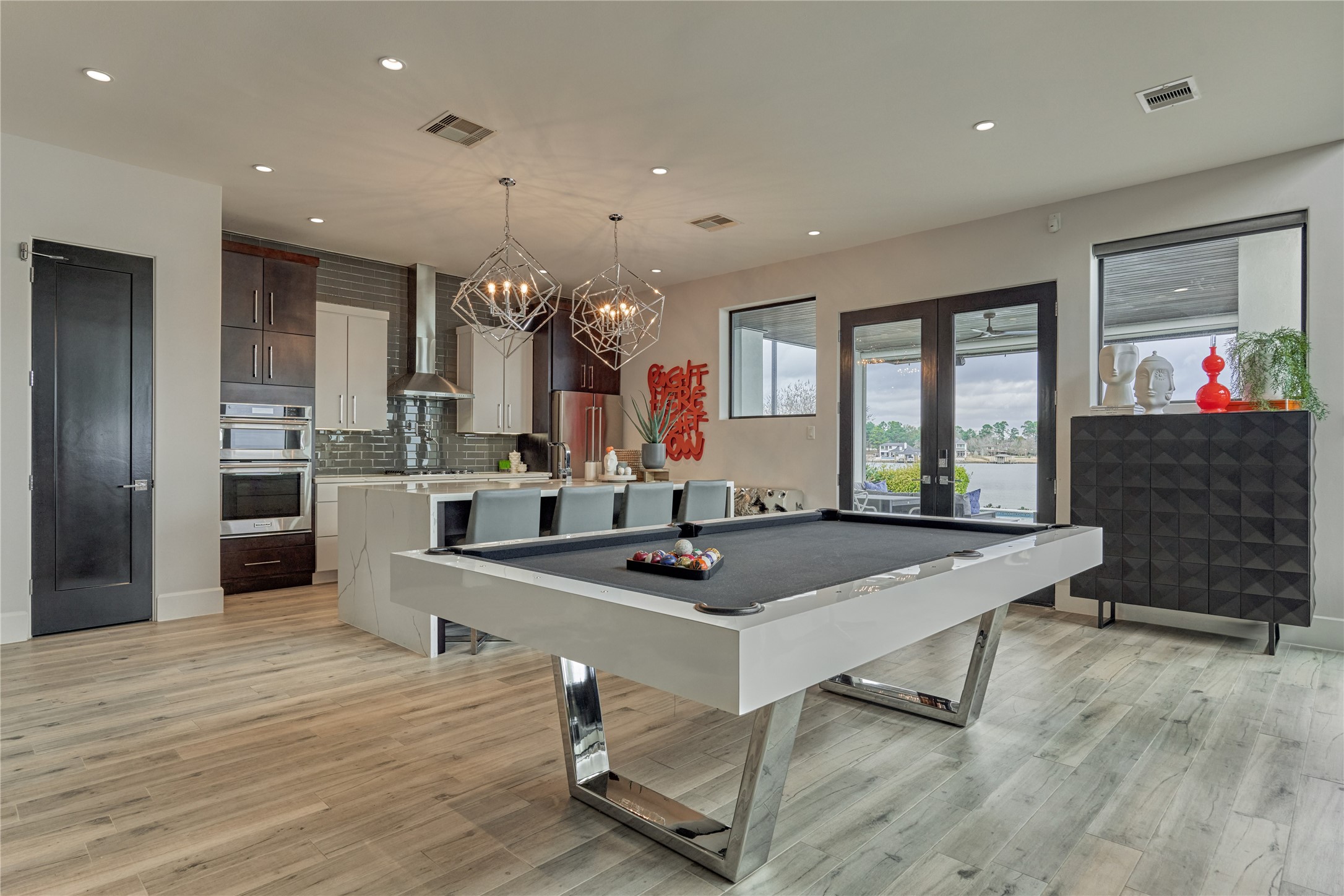 189 Stevinstraat Montgomery, TX 77356 - Photo 15 of 50 a room with stainless steel appliances kitchen island granite countertop a table chairs and a refrigerator