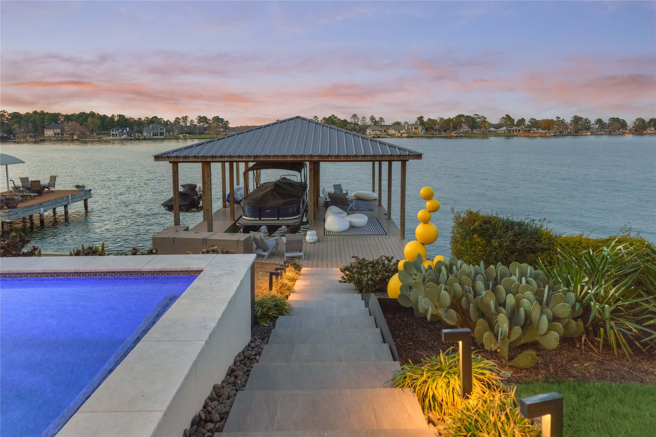 189 Stevinstraat Montgomery, TX 77356 - Photo 40 of 50 Stairs lead down to the boathouse, lake and sundeck. There is a shower on the boat dock to wash off before going into the house.