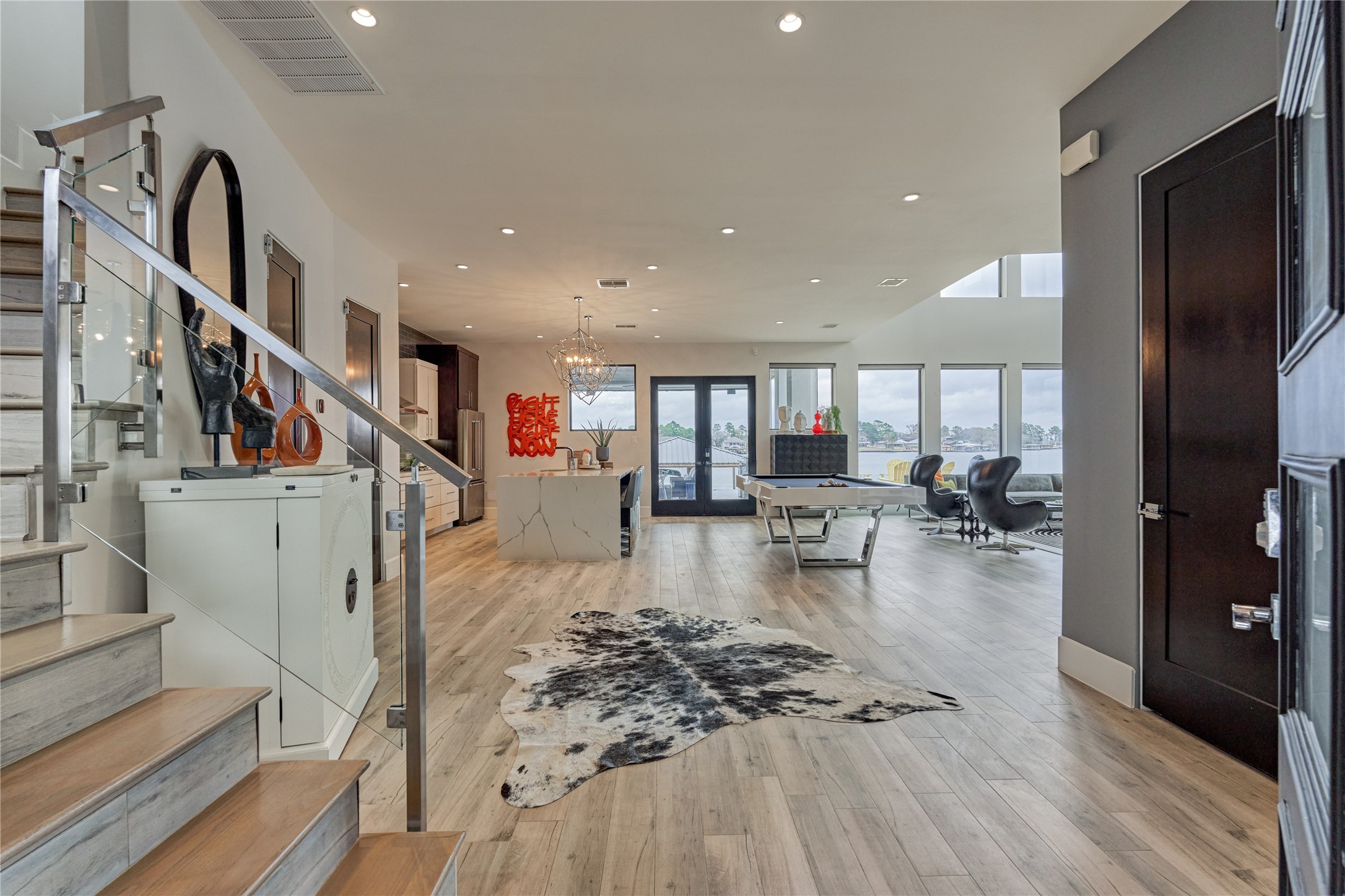 189 Stevinstraat Montgomery, TX 77356 - Photo 8 of 50 Welcome to an open-concept interior, appointed with lavish details throughout! Upscale features include wood-look tile flooring, motorized shades w/ remotes, 8 ft black doors, tall baseboards and more!