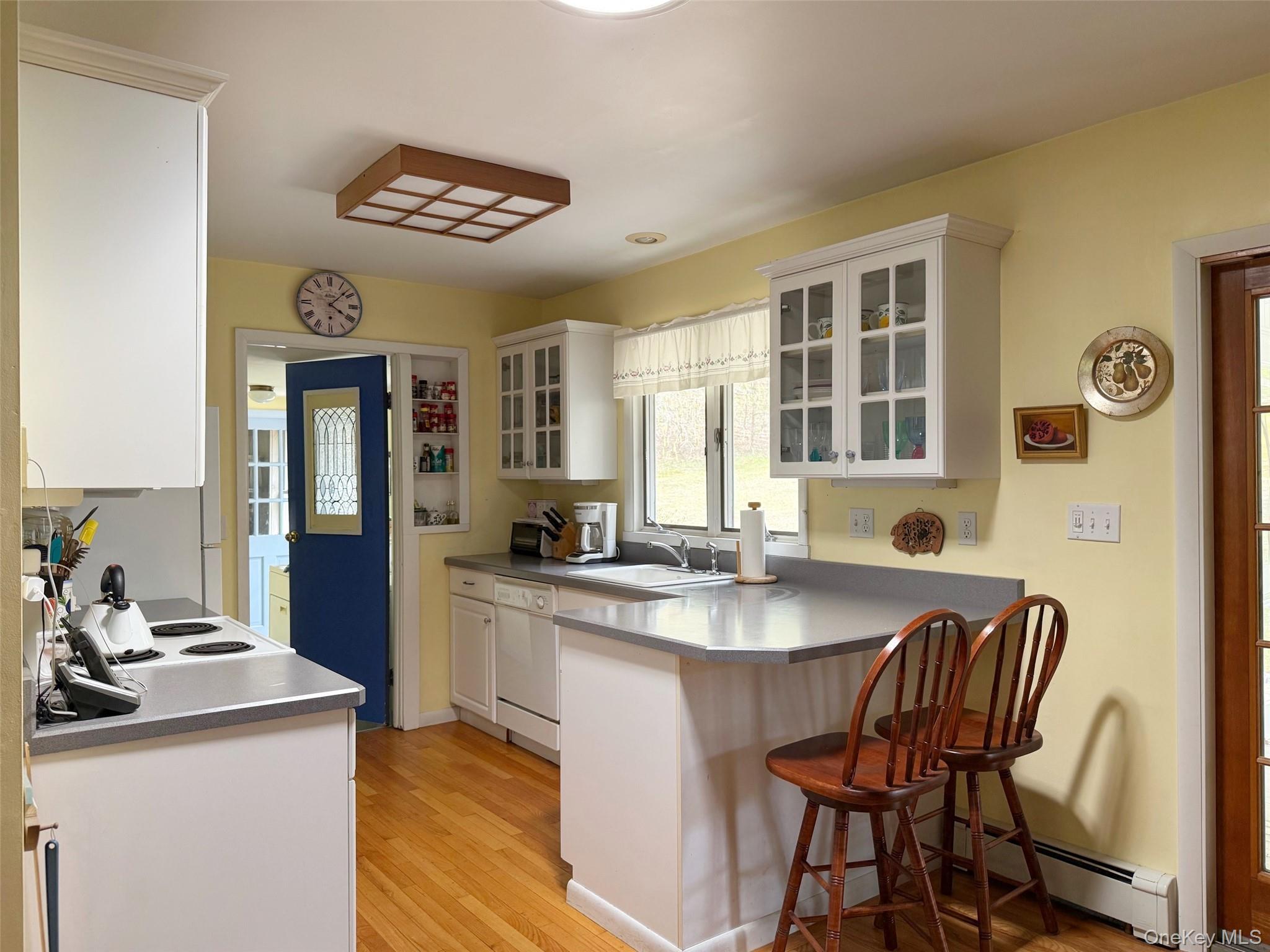 230 Cooper Road Millerton, NY 12546 - Photo 7 of 20 a kitchen with a dining table and chairs