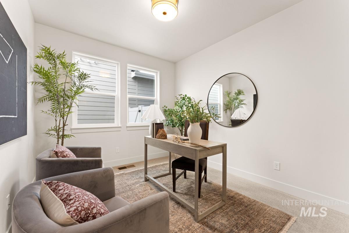 13338 North Spring Creek Way Boise, ID 83714 - Photo 12 of 46 Bright room featuring two large windows, overhead flush-mount lighting, and light-toned carpeting